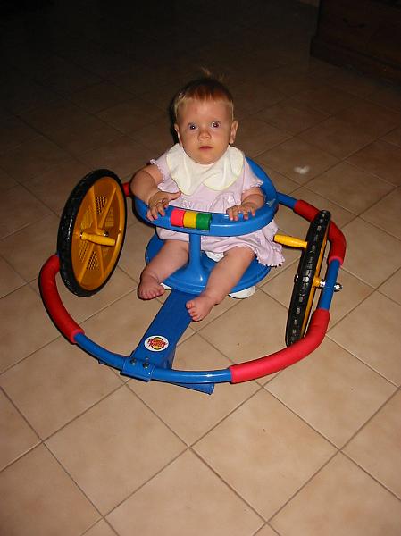 0-17.JPG - It was at the annual Spina Bifida Association of America conference that Esther entered a raffle and won first prize, this Whirly Wheels toy. Kika was too little for it at the time, so we put her little chair on it so she could enjoy it.