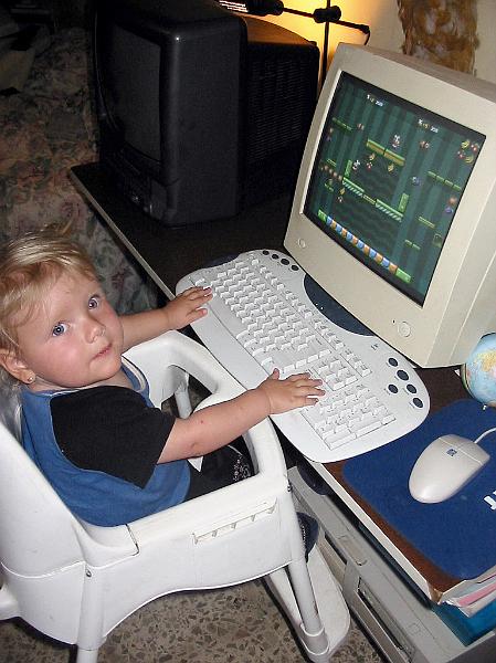2-15.JPG - Kika has started showing interest in playing on the computer. She doesn't really know what she is doing, but has fun doing it.