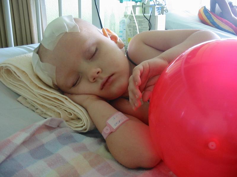 4-19.JPG - December 6, 2005 - We put Kika on her side as she starting developing sores on her back. The ball was given to her by some people giving out presents to all the children in the hospital. It is Christmas time so just about every day someone comes by with something for the kids.