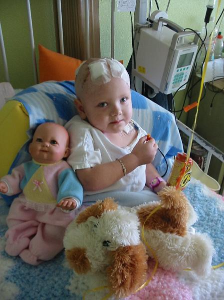 4-29.JPG - Eating Cheetos with her new baby and Woofie.