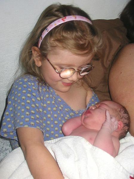 7-13.jpg - Kika holding her new baby sister, Jacqueline, moments after her birth.