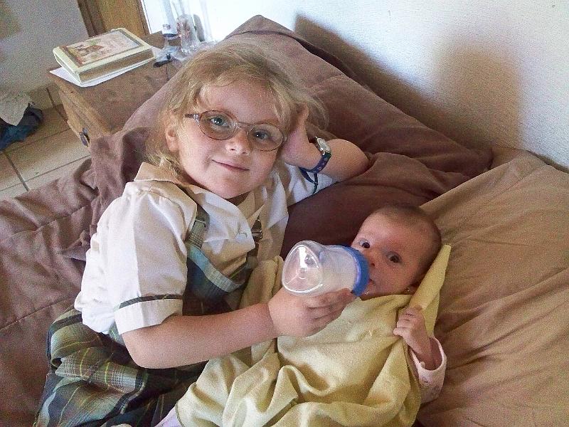 7-19.jpg - Feeding her new baby sister